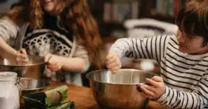 young child stirring food in a mixing bowl